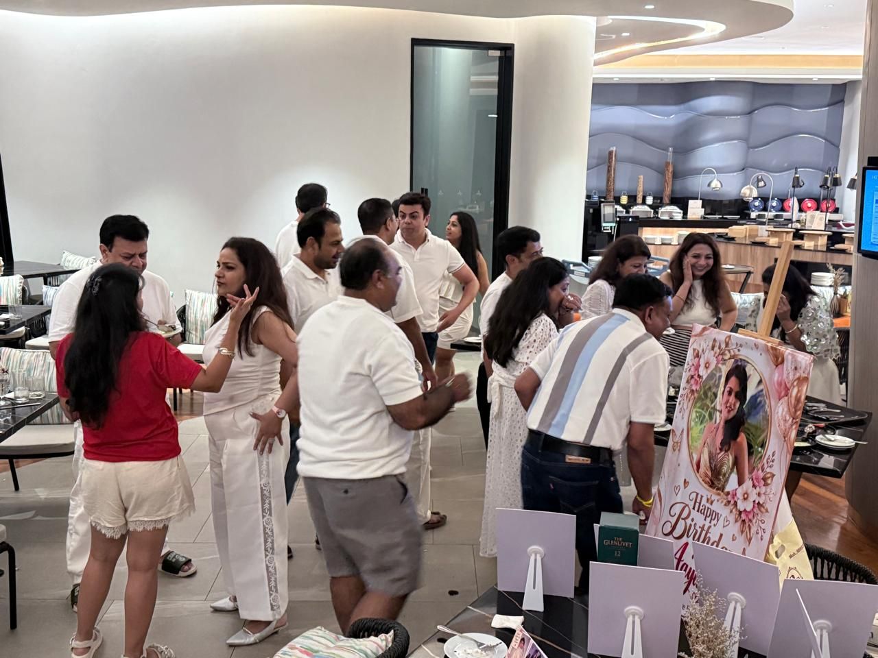 Guests in white at the welcome desk
